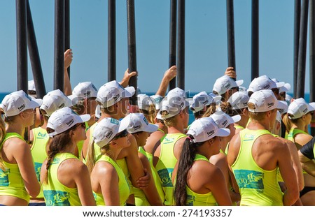 COLLAROY,AUSTRALIA - APRIL 25,2015: Surf lifesavers raise their oars in salute as they commemorate the centenary of the ANZAC landings at Gallipoli. Several local surf lifesavers died in the campaign.