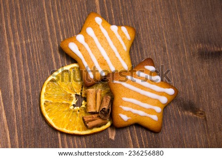 Christmas cookies with orange and cinnamon on wooden table