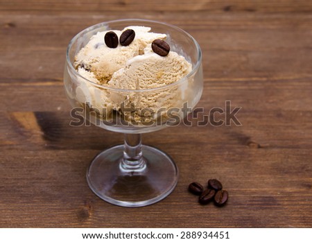 Cup of coffee ice cream on wooden table