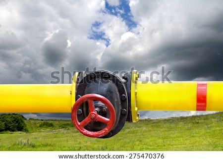 Yellow gas pipe and red valve outdoor