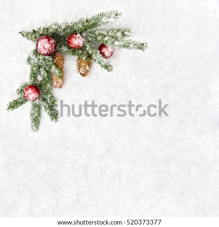 Christmas decoration. Branch christmas tree, christmas balls and cones spruce on snow. Top view, flat lay