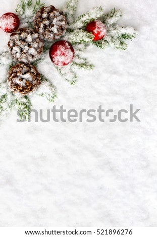 Christmas decoration. Branch christmas tree, christmas balls and cones pine on snow. Top view, flat lay