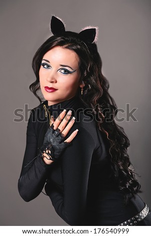 Portrait of beautiful young european model in cat make-up and costume