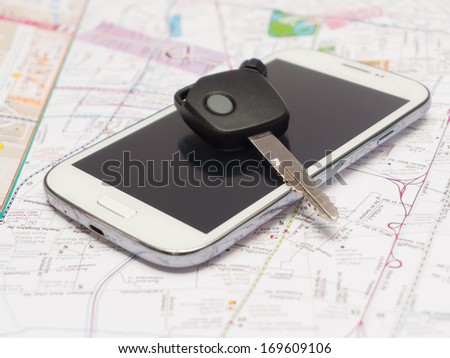Mobile phone and key car on the map.travel concept.