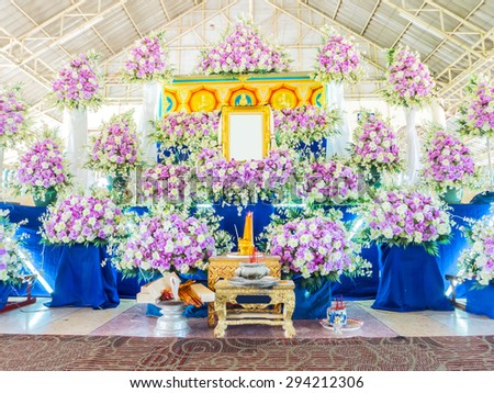PETCHBURI, THAILAND - JUNE 06, 2015 : Flower decoration and picture frame in front of coffin at  Thai funeral.