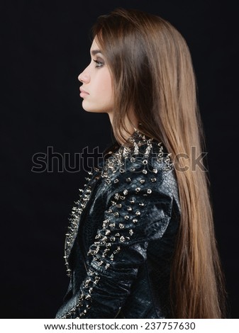 long-haired girl in a leather jacket with studs