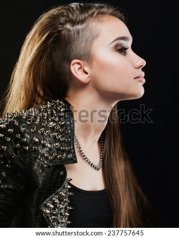 long-haired girl in a leather jacket with studs