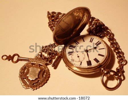 Macro sepia effect of old pocket watch and key