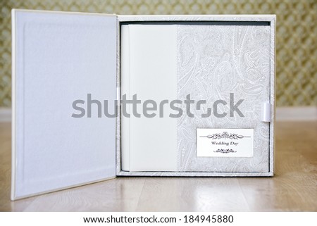 Wedding photo book with leather combined cover and metal shield in box for wedding photo book