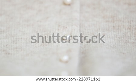 Angora wool cardigan with pearl button. Extreme shallow depth of field. Focused on button.