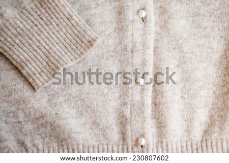 Angora wool cardigan with pearl button. Selective focus.