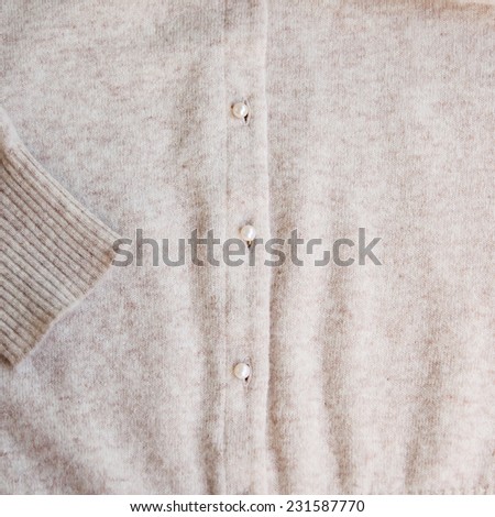 Angora wool casual pastel color cardigan with pearl buttons. Close up