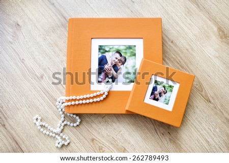 Wedding photo book and box for CD with orange leather cover and passe-partout