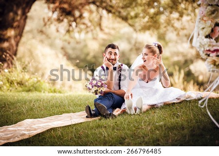 Groom and bride enjoy their wedding day. Bride wears shoes with inscription 