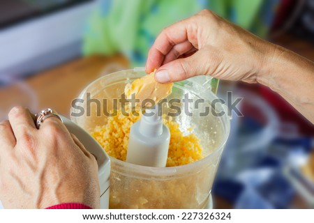Hand working on food processor