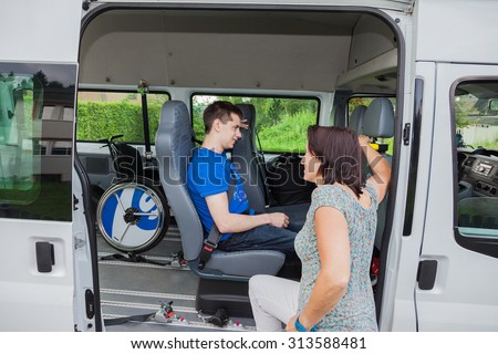 Handicapped boy is picked up by school bus
