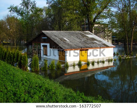 Flooded house on a river bank