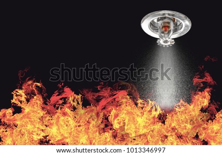 Image of Fire Sprinklers Spraying with fire background. Fire sprinklers are part of an overall safety protocol for fire and life safety.