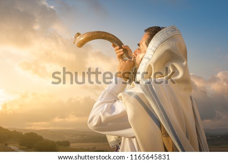 A Jewish man blowing the Shofar (ram's horn), which is used to blow sounds on Rosh HaShana (the Jewish New Year) and Yom Kippurim (day of Atonement)