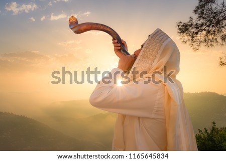 A Jewish man blowing the Shofar (ram\'s horn), which is used to blow sounds on Rosh HaShana (the Jewish New Year) and Yom Kippurim (day of Atonement)