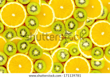 Fruity background set of slices of orange fruit and kiwi. Many slices of kiwi fruit and orange fruit, Fresh kiwis and orange fruit, interesting fruit composition