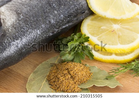 Seabass with with spices, parsley, dill and lemon isolated on white background