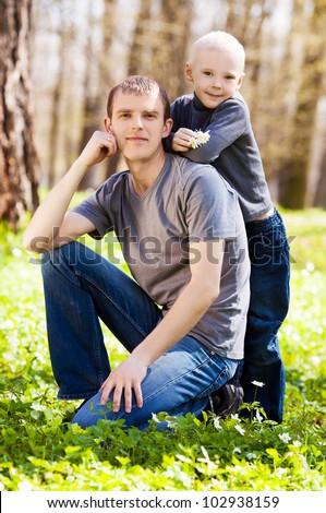 happy  family; young father and his six year old son spending time outdoor on a summer day