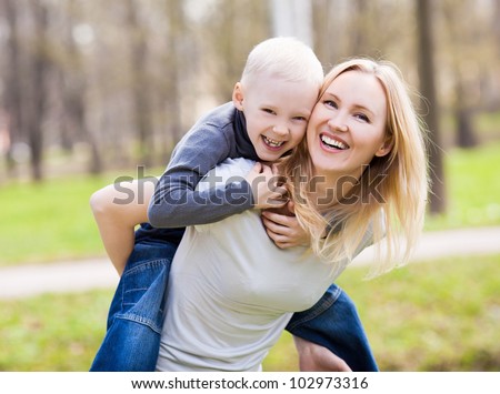 happy  family; young mother and her six year old son spending time outdoor on a summer day