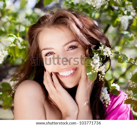 beautiful laughing brunette woman in the park on a warm summer day