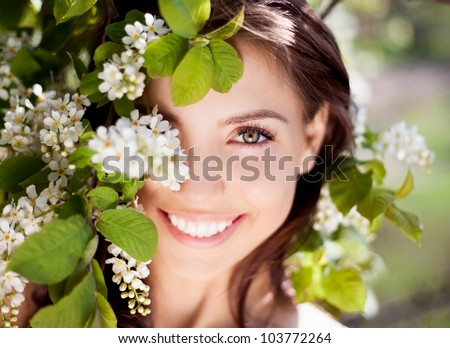 beautiful happy brunette woman in the park on a warm summer day