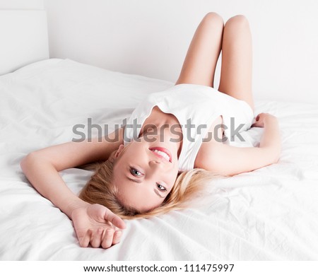 happy woman  on the white linen in bed at home