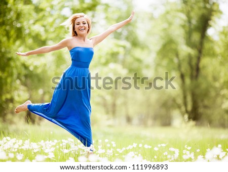 happy young blond woman outdoor on a summer day