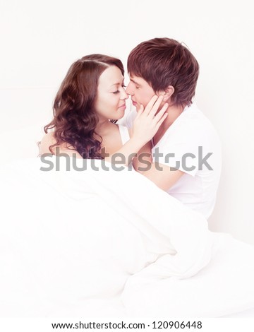 happy young beautiful couple in bed at home