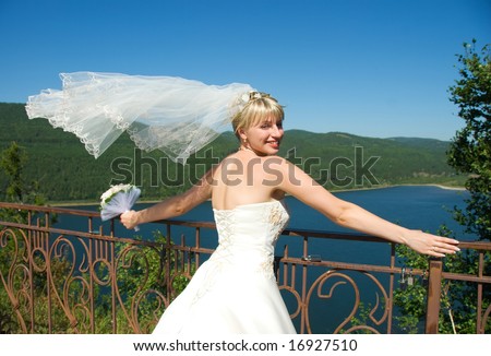 pretty young bride with a flying veil outdoor
