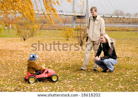 happy mother and father playing with their son outdoor