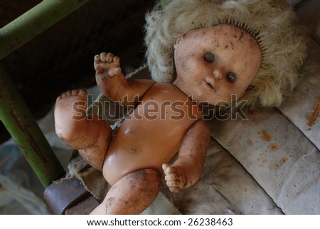 picture of poverty, old dirty doll on the rusty iron bed with an old dirty mattress