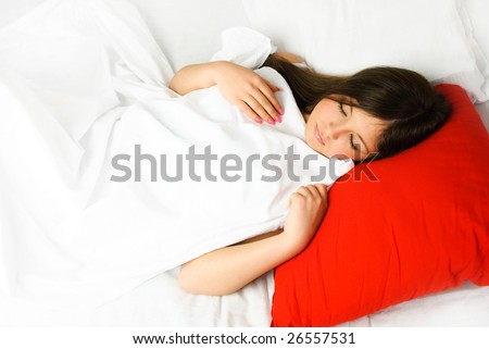 beautiful young brunette woman sleeping in her bed peacefully