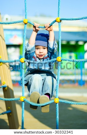 cute three year old boy playing outdoor at the Children\'s playground