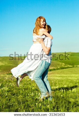 happy young loving couple having fun outdoor in summertime