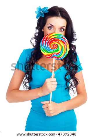 pretty surprised brunette girl with a lollipop in her hand