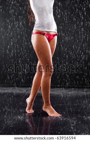 young sexy slim woman walking barefoot under the rain