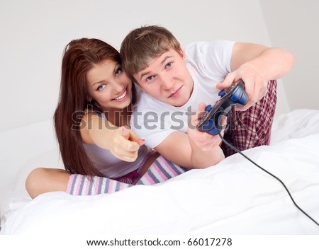 happy young teenage couple playing computer games