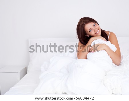 pretty brunette girl sleeping on the white linen