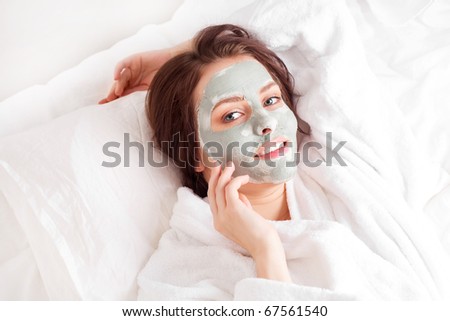 young woman wearing a deep cleansing green clay mask