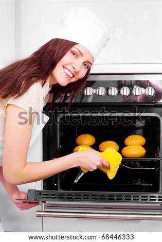 beautiful young woman baking bread  in the kitchen