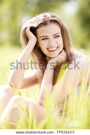 beautiful laughing young woman  in the park  on a warm summer day