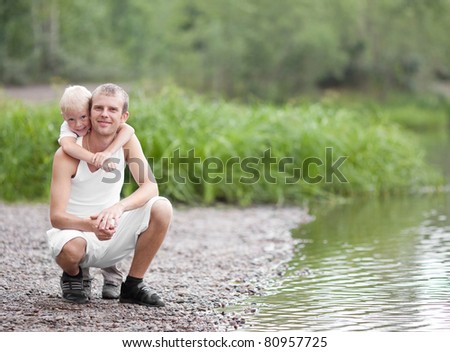 happy  family; young father and his five year old son near the lake outdoor on a summer day
