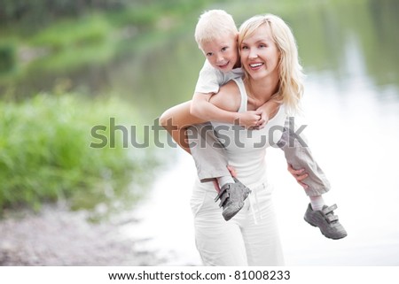 happy  family; young mother and her five year old son spending time outdoor on a summer day
