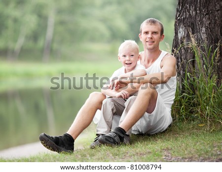 happy  family; young father and his five year old son spending time outdoor on a summer day (focus on the child)