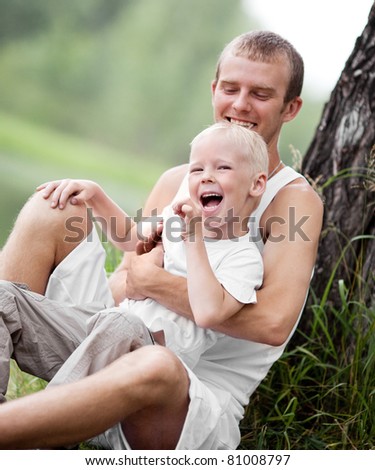 happy  family; young father and his five year old son spending time outdoor on a summer day (focus on the child)